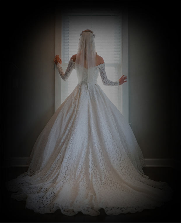 a bride looking staring on the window