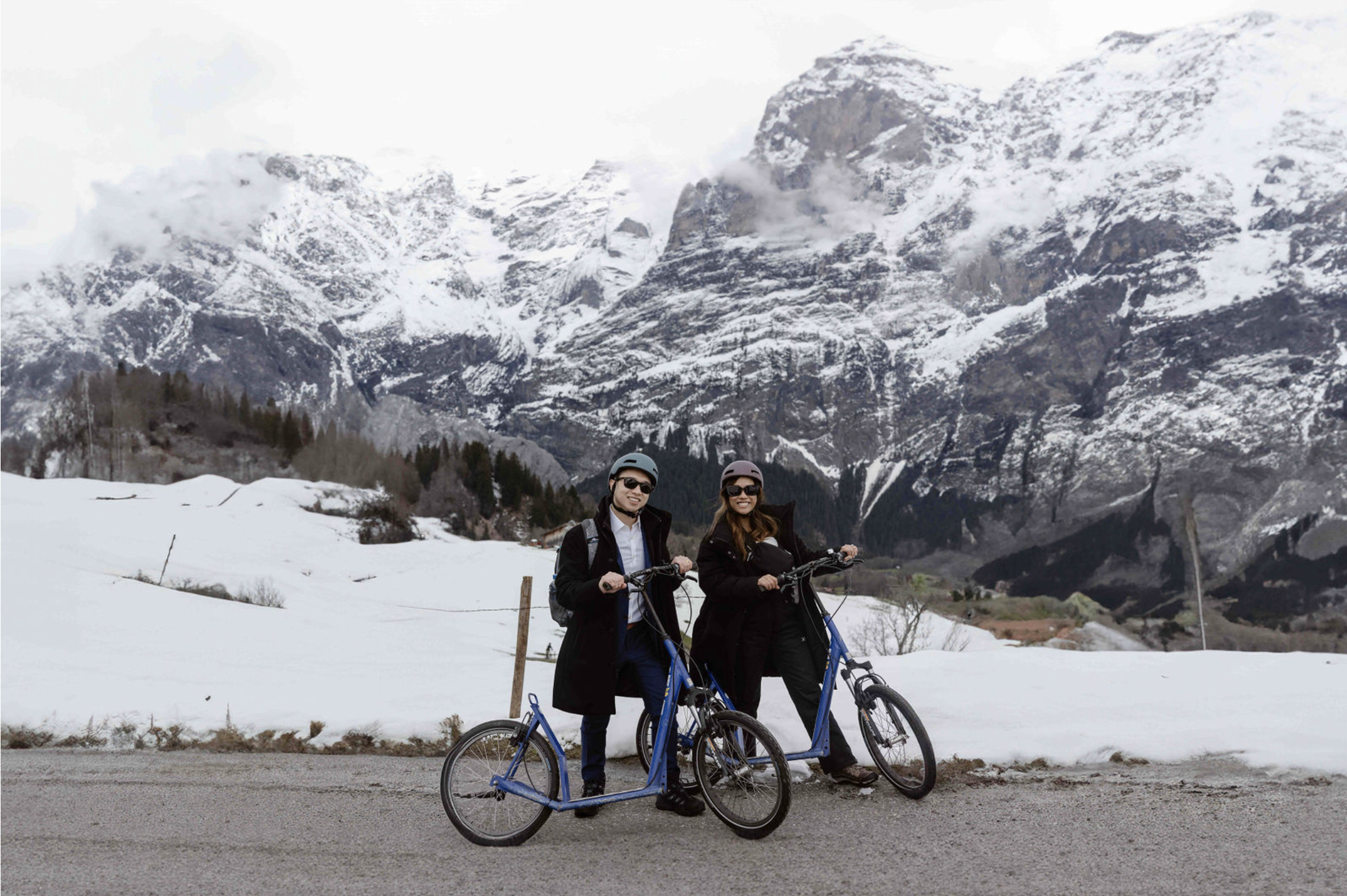 bride and groom trotti biking in grindelwald, switzerland during their elopement in spring
