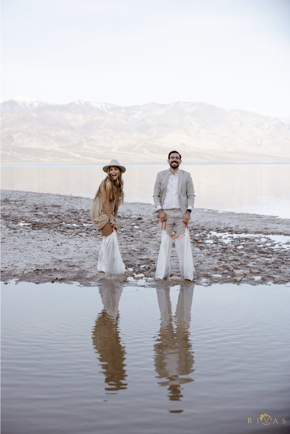 Hugo and Ivonet trash bags Lake Manly Death Valley elopement